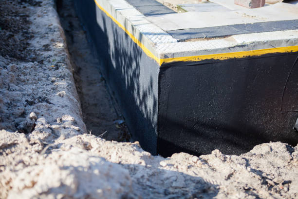 Professional Basement Waterproofing technician working in Burnsville, NC